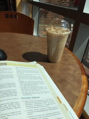 Reading with a large iced chai