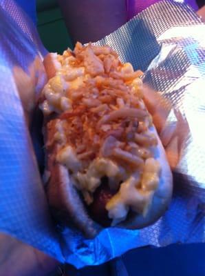 Mac hot dog with fried onions on top.