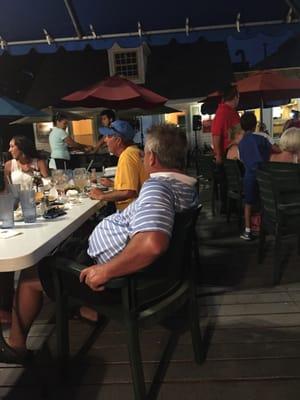 People on the deck listening to karaoke.