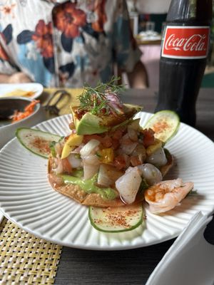 Tostada VIP Ceviche: cured scallops, sea bass crudo, poached shrimp, avocado, mango pico, guacasalsa