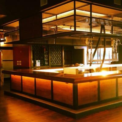 Baker st pub. Custom welded overhead liquor cages and walnut trimmed in steel bar face with a walnut bar top