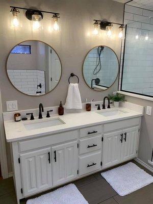 Farmhouse vibes with this Carrera White Quartz was installed in the shower, pony walls, and vanity countertop!