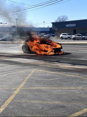 Car catching fire just a few feet from there shop.