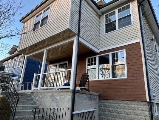 New windows and dark brown accent siding.