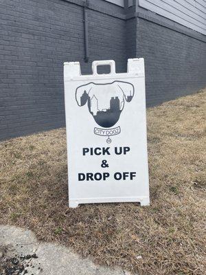 Look for the pick up & drop off sign on the side of the building located on Oliver street.