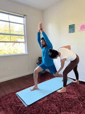 Correcting the alignment of asana of a practitioner in a 1 on 1 Yoga Session.