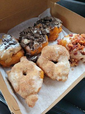 Top left to right- chocolate chip cookie dough;  2 regular oreo. Bottom left to right- 2 cinnabon; maple bacon