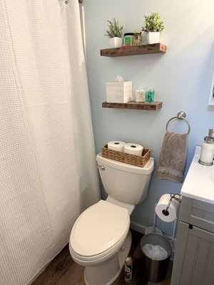 Add some floating shelves and mounted hooks to easily upgrade a bathroom!