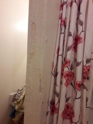 Wall falling apart from leak in bathroom