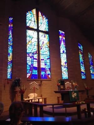 The stained glass backdrop of the church.