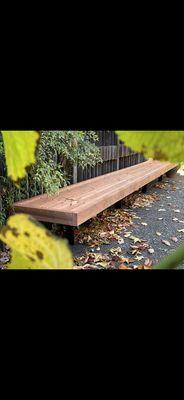 Wood Bench 17' long with metal angle steel plates bolted down to the Concrete