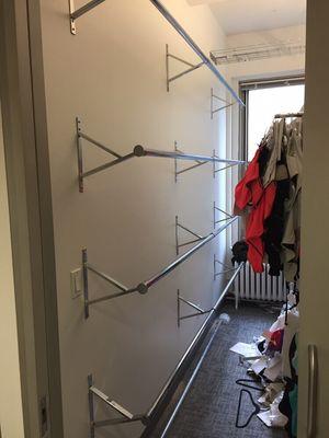 Corporate office hanging bar installation for clothes.