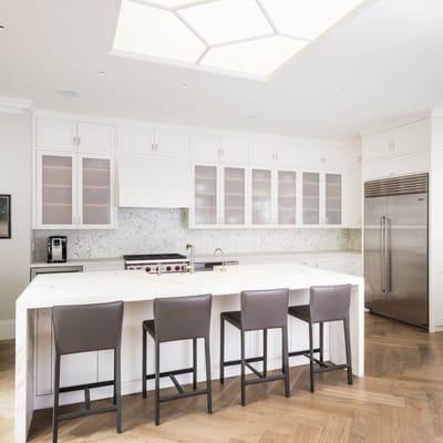 Contemporary Kitchen with custom cabinetry and Neolith waterfall countertop, and herringbone oak flooring.