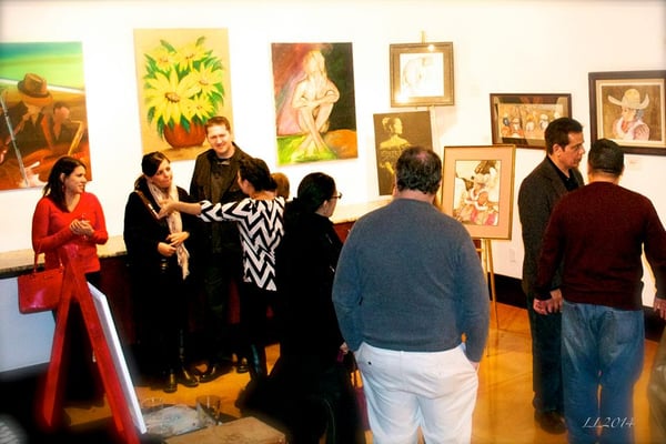 Art for Keeps Studio visitors viewing Bobby and Richard Mendoza's paintings