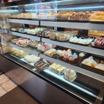 3 glass counters of pastries galore.