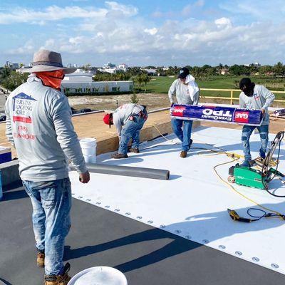 Installing a new TPO flat roof to a modern style mansion in Fort Lauderdale, FL.