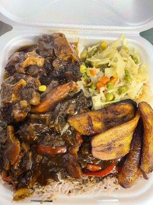 Oxtail with rice & peas, steam cabbage & fried plantain