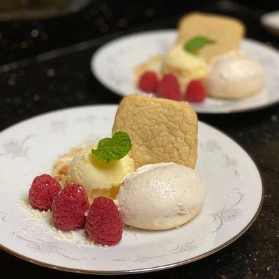 Dessert of Lemin Sherbet with Lemon Cookies,  Meringue,  and fresh Raspberries