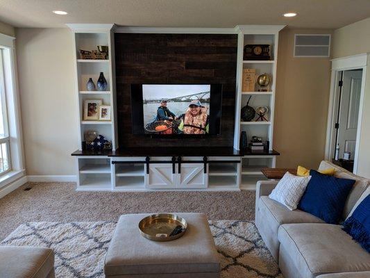 Custom Built-In Entertain Center with barn wood back drop and barn doors.