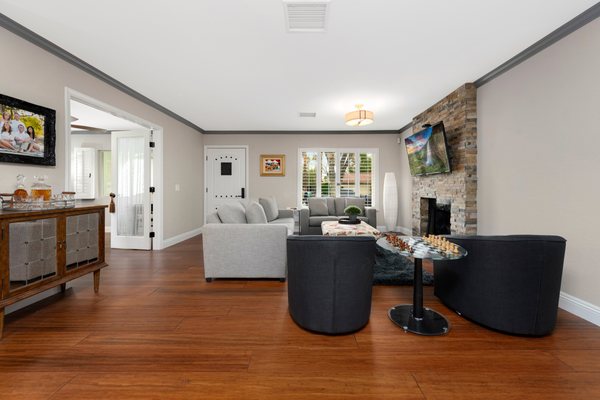 New bamboo flooring, crown moulding, fireplace face with wall-hung TV made for the perfect space.