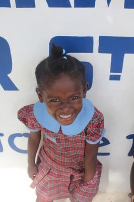 A happy patient waits outside our clinic in Haiti!