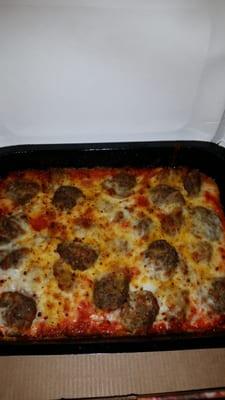 Meatball and sausage bake topped with cheese