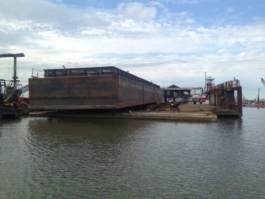 Large oil field waste barge on drydock