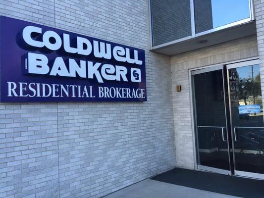 Coldwell Banker Entrance is next to (separate from) the main entrance of the tall main building.