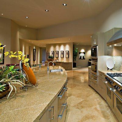 Beautiful modern Mediterranean kitchen with natural countertops, tile and built-in appliances.