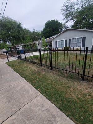 Wrought Iron fencing with single track remote access gate.