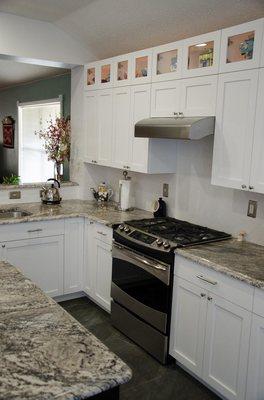 Beautiful white, all wood cabinetry with upper glass & lighted niches allow you to safely display antiques and collectibles