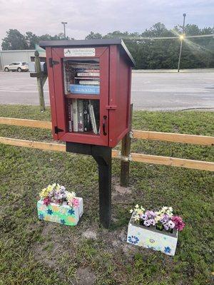 We have an official Little Free Library located in the fenced in section in front of our office.