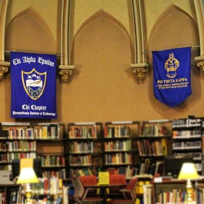 Phi Theta Kappa Honor Society, Alpha Psi Mu Chapter & Chi Alpha Epsilon Honor Society, Chi Chapter banners hang in the P.I.T. Library.