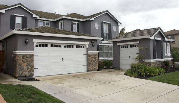 Fully insulated white three car garage doors with long panel beautiful clear glass Design and black hardware to give it that pop!