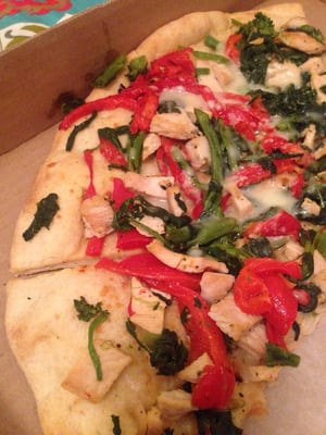 Delicious crunchy pizza with spinach, roasted red peppers, and grilled chicken