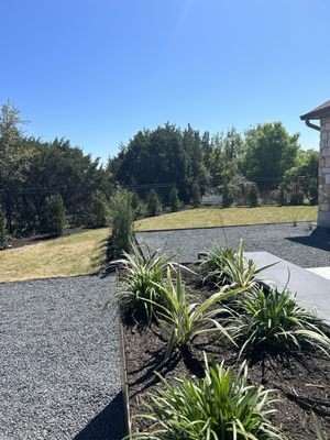 Black gravel, zyosia grass, raised steel beds, Japanese yews, and our whole perimeter lined with amazing trees