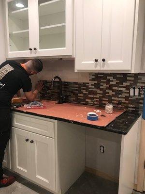 Back splash tile installation.