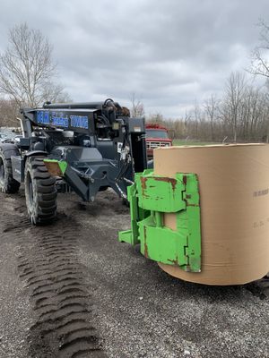 Telehandler with paper roll clamp