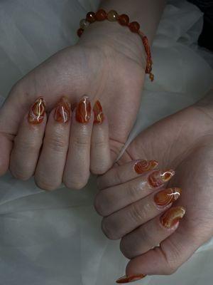 Carnelian-inspired nail art on short gel-x extensions