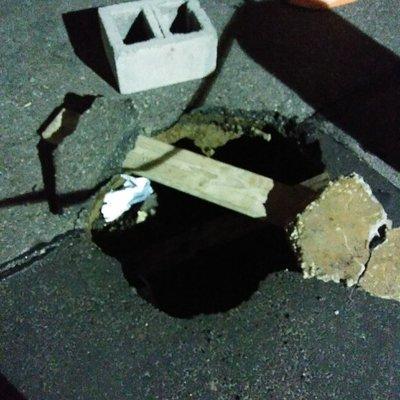 Cesspool cave in. Notice the blacktop is being held up by the soil but no cesspool is holding everything up.