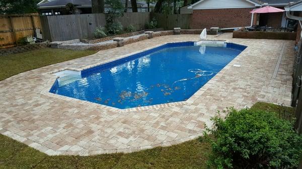 Hardscape pavers around fun pool area.