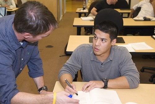 A Veritas Prep instructor helps a student work through a problem in a recent Cambridge GMAT prep class