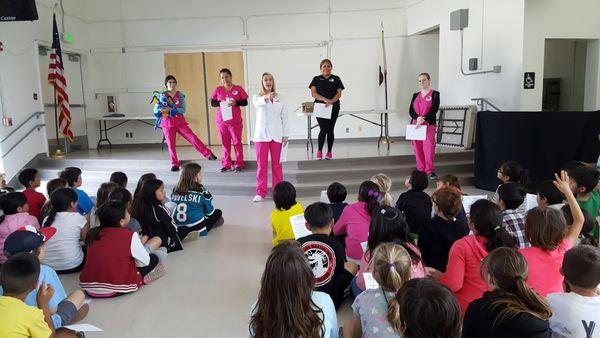 Blanco Family Dental Volunteering to teach children at one of our local schools the importance of proper oral hygiene.