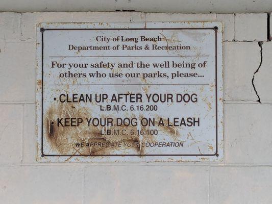 Clean up after your dog! And clean up the sign too!