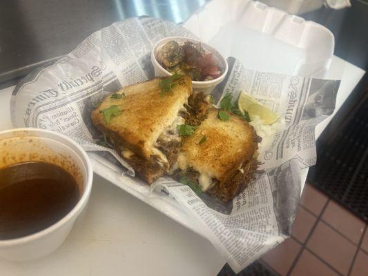 Birria grilled cheese! With a side of our fresh cucumber dill tomato salad!