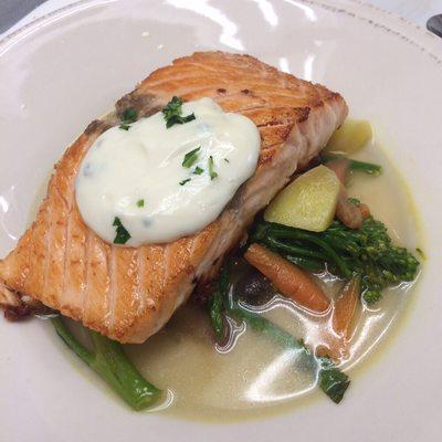 Pan seared Salmon in a light spring vegetable broth w chive aioli ( by Chef Darren Atkins)