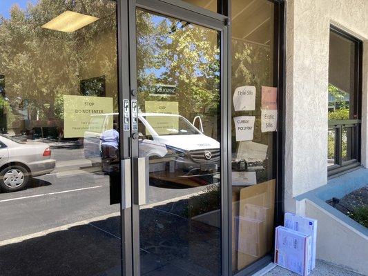 Signs showing appointments and curbside only.