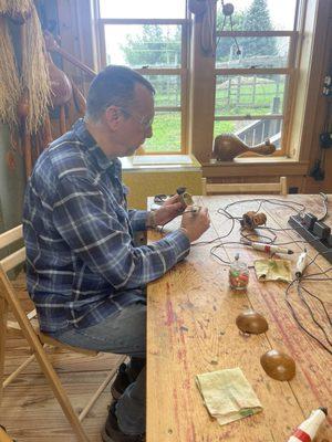 My husband making his nightlight gourd