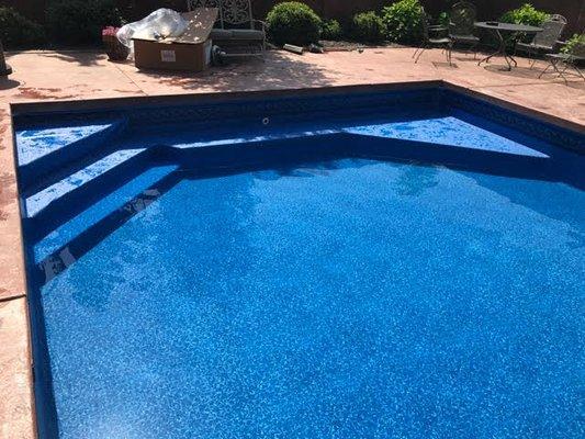 Pool liner with custom step and benches.