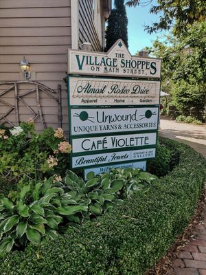 Entrance to Cafe Violette is past this sign, towards the back